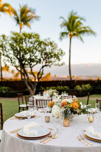 a table with a white table cloth and flowers on it at Waikoloa Beach Marriott Resort & Spa in Waikoloa