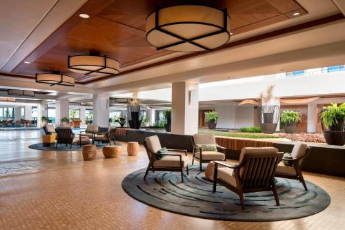 a lobby of a hotel with chairs and tables at Waikoloa Beach Marriott Resort & Spa in Waikoloa