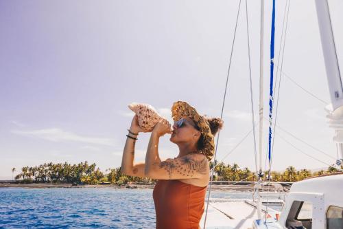 a woman standing on a boat looking at the water at Waikoloa Beach Marriott Resort & Spa in Waikoloa