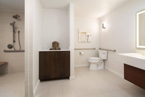 a white bathroom with a toilet and a sink at Waikoloa Beach Marriott Resort & Spa in Waikoloa