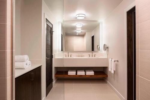 a white bathroom with a sink and a mirror at Waikoloa Beach Marriott Resort & Spa in Waikoloa