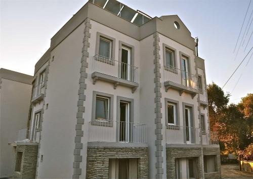 a white building with balconies on top of it at Zena Hotel Bodrum in Guvercinlik