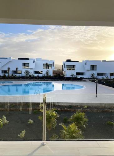 a view of a building with a swimming pool at AD apartment in La Oliva
