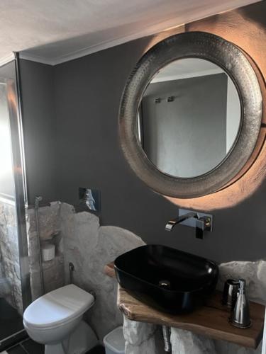 a bathroom with a black sink and a mirror at Villa Francesca - Manfredi Homes&Villas in Monte SantʼAngelo