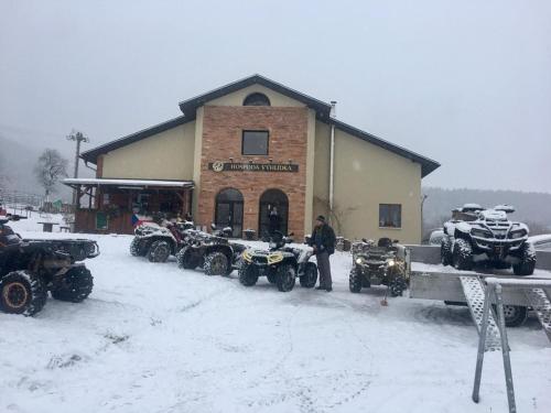a man standing in front of a building with a bunch of atvs at Pension Vyhlídka in Klášterec nad Ohří