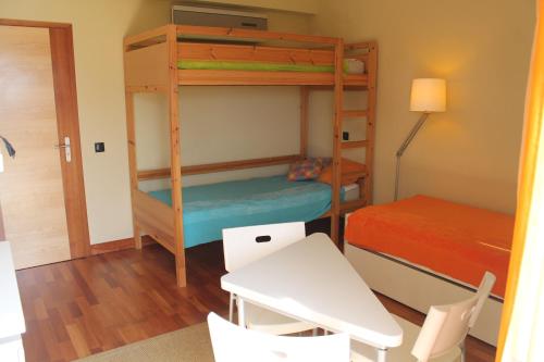 a room with two bunk beds and a table and chairs at Top Quality Apartment in Lagos