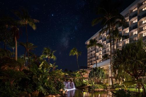 a hotel with a waterfall and palm trees at night at The Westin Maui Resort & Spa, Ka'anapali in Lahaina