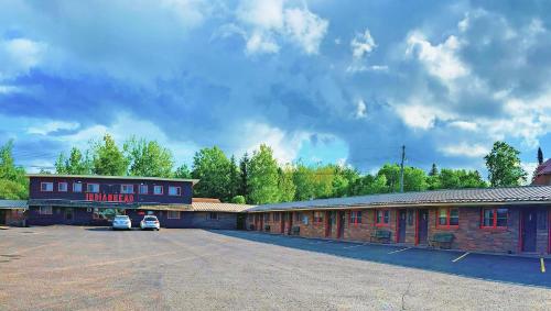 an empty parking lot in front of a building at Indianhead Ironwood Hotel in Ironwood