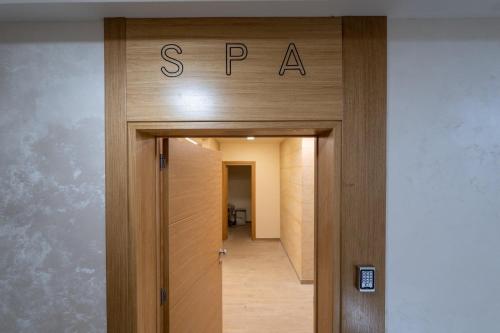 a sign that reads spa above a door at NEO Apartman in Zlatibor