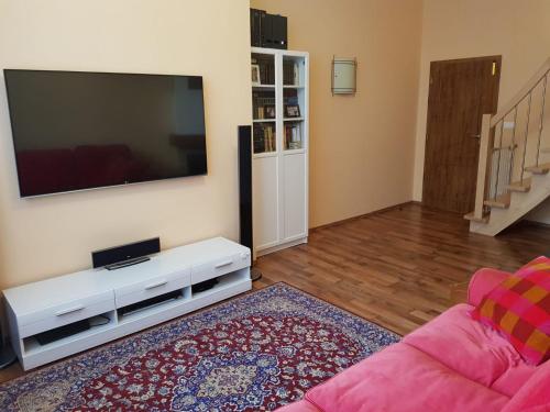 a living room with a large flat screen tv at Apartman Moravska 188 in Karlovy Vary