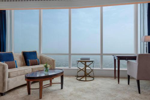 a living room with a couch and a table at The St. Regis Abu Dhabi in Abu Dhabi