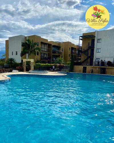 a large pool of blue water in front of a building at Apartasol Villa Sofia, Reserva de la Colina, La Tebaida, Quindio in La Tebaida