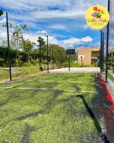 an empty tennis court with a sign on it at Apartasol Villa Sofia, Reserva de la Colina, La Tebaida, Quindio in La Tebaida
