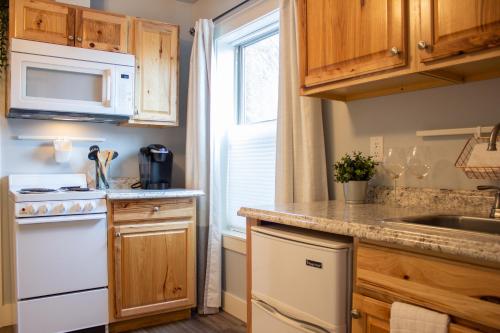 a kitchen with wooden cabinets and a white appliance at Douglas On Third in McMinnville