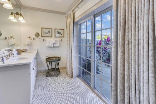 a bathroom with a sink and a large glass door at Townhouse 3 Bedroom B in Holmes Beach