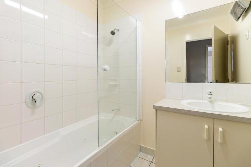 a white bathroom with a sink and a shower at Sunny Apartment Methven in Methven