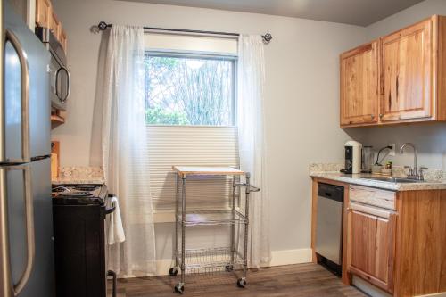 a kitchen with a sink and a window at Douglas On Third in McMinnville