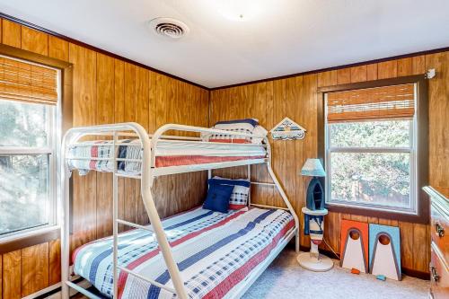 a bunk bed in a room with wooden walls at Costa Na Mara in Frisco
