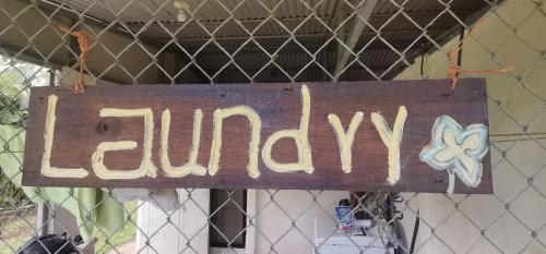 a sign that readsulum is hanging on a fence at Granja Agua Azul, Wi-FI,AC-WC,Parking,la Fortuna in Fortuna