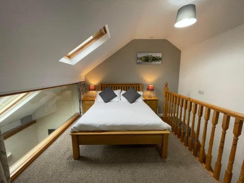 a bedroom with a bed and a staircase at Embleton Spa Hotel & Apartments in Embleton
