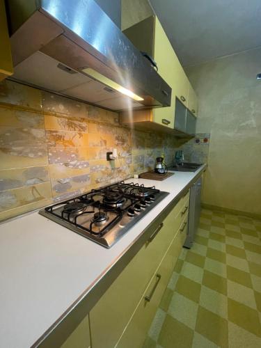 a kitchen with a stove top oven in a kitchen at CASA EVA in Celano
