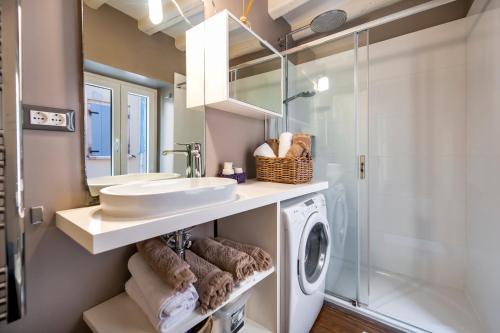 a bathroom with a sink and a washing machine at Apartment Mediterraneo in Rovinj