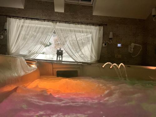 a man standing in a bath tub in a window at Willa pod Czantorią SPA Ustroń in Ustroń