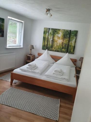 a bed with white sheets and pillows in a bedroom at Naturpanorama in Gleiszellen-Gleishorbach