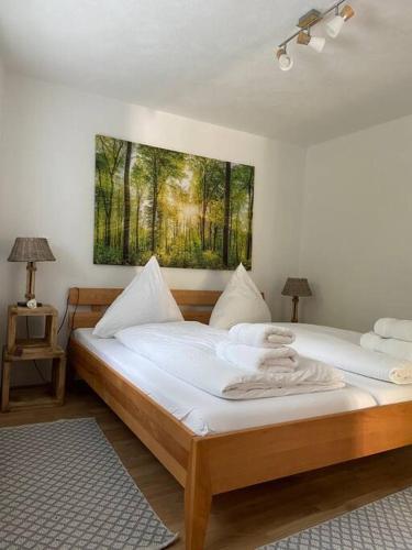 two beds in a room with a painting on the wall at Naturpanorama in Gleiszellen-Gleishorbach