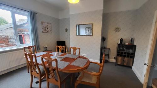 a dining room with a wooden table and chairs at STAY - at Southport Holiday Home - sleeps 6 in Southport