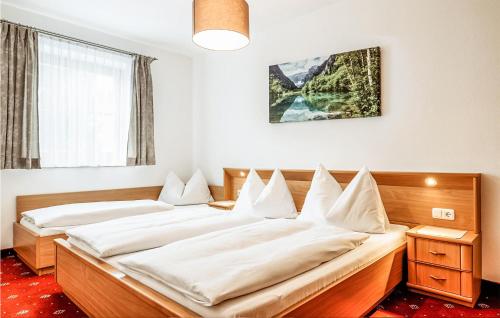 a bedroom with two beds with white sheets at Amazing Apartment In Grossarl With 2 Bedrooms And Wifi in Grossarl