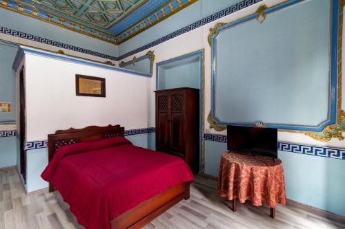 Ένα ή περισσότερα κρεβάτια σε δωμάτιο στο Hotel Majestic 1 Centro histórico Cuenca