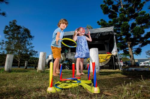 a boy and a girl playing with hula at Reflections Ferry Reserve - Holiday Park in Brunswick Heads