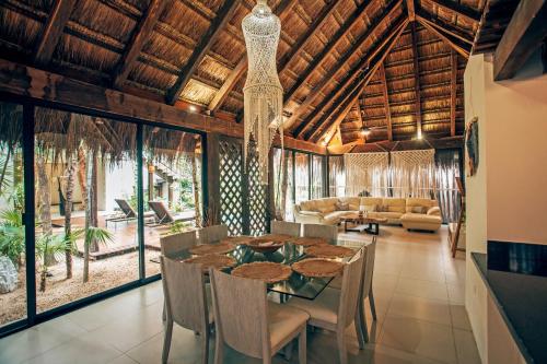 a dining room with a table and chairs at Orchid House Tulum in Tulum