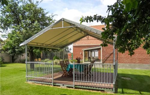 a pergola with a table in a backyard at Cozy Home In Merkem With Wifi in Merkem