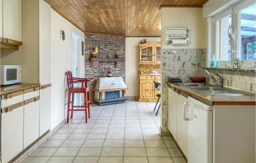 a kitchen with a sink and a stove at Cozy Home In Merkem With Wifi in Merkem