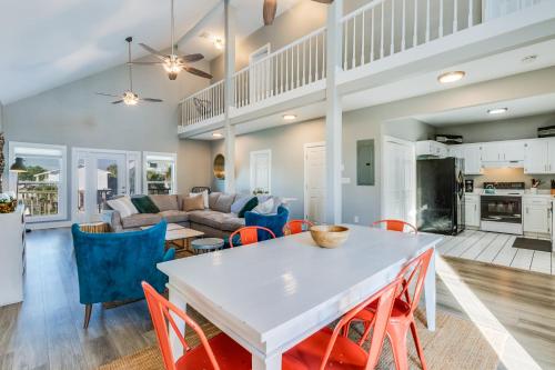 a kitchen and living room with a white table and chairs at Modern, 3 BR Private House within Walking Distance to the Beach! in Gulf Shores