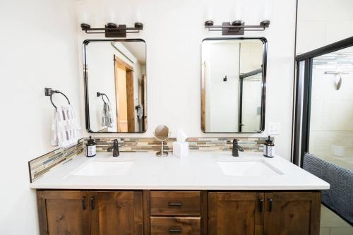 a bathroom with a sink and two mirrors at Close to RMNP, Estes,& Amenities in Estes Park