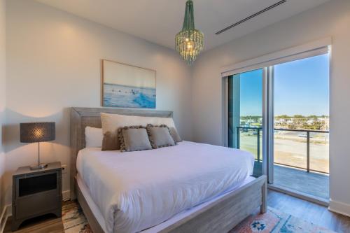 a bedroom with a bed and a large window at Enjoy the perfect Getaway at Gulf Place 4 BR Condo next to the Hangout! GP 304 in Gulf Shores
