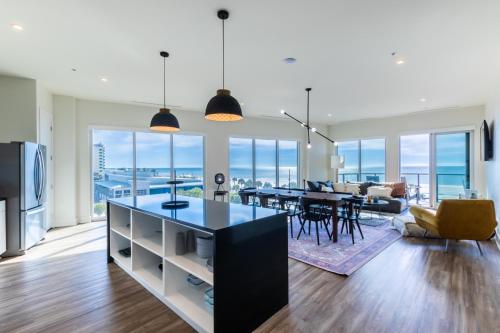 a living room with a kitchen and a dining room at Spacious 4 BR Beachfront, Luxury Condo Next to the Hangout- GP 301 in Gulf Shores