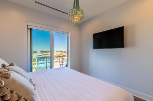a bedroom with a large bed and a large window at Modern 4 BR Luxury Condo with Rooftop Pool Next to the Hangout! in Gulf Shores