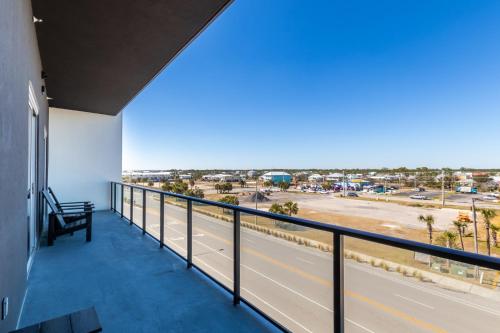 a balcony with a view of a highway at Modern 4 BR Luxury Condo with Rooftop Pool Next to the Hangout! in Gulf Shores