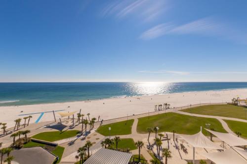 a view of the beach from the balcony of a resort at Modern 4 BR Luxury Condo with Rooftop Pool Next to the Hangout! in Gulf Shores