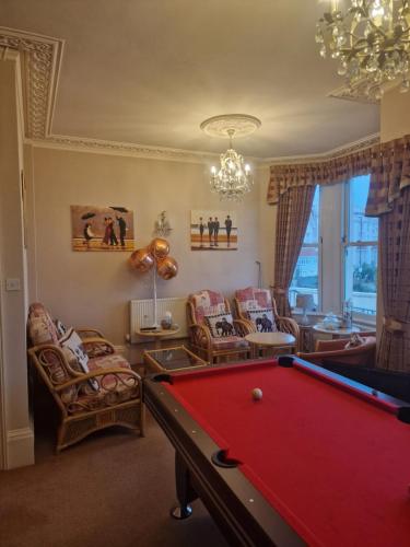 a living room with a pool table at The Sands Hotel in Paignton