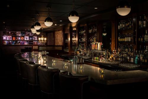 a bar with a lot of bottles of alcohol at The Armstrong Hotel in Fort Collins