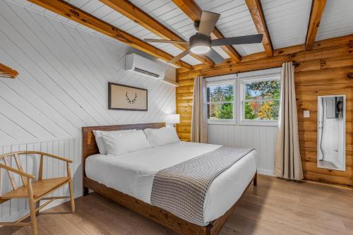 a bedroom with a bed and a ceiling fan at The Wells Cashiers in Cashiers