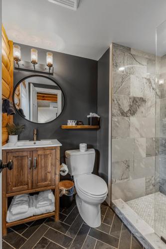 a bathroom with a toilet and a sink and a shower at The Wells Cashiers in Cashiers