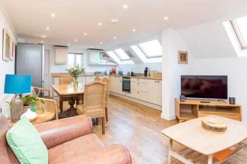 a living room with a couch and a table at Barn Cottage -Westerlands in Graffham