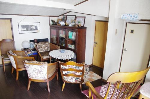 a dining room with a table and chairs at Ryokan Takayama in Takayama