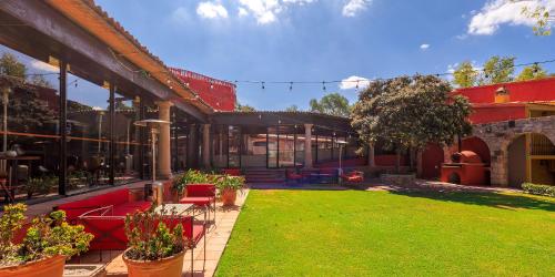 a house with a lawn in front of it at Real de Minas San Miguel de Allende in San Miguel de Allende